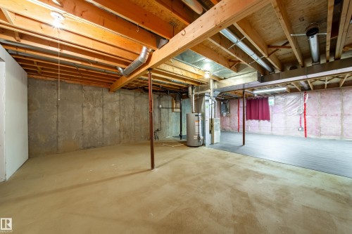 Unfinished basement with exposed wood joists and concrete flooring - 120 13320 124 Street Nw, Edmonton, AB 