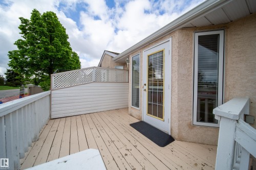 Exterior deck featuring a white railing and privacy lattice - 120 13320 124 Street Nw, Edmonton, AB 