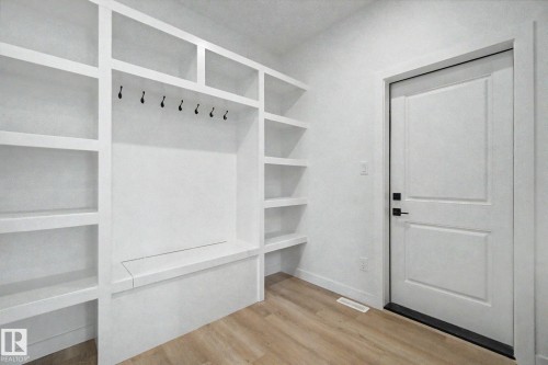 Built-in white shelving system with integrated bench seating and multiple storage cubbies - 2 Willow Heights Drive, Stony Plain, AB 