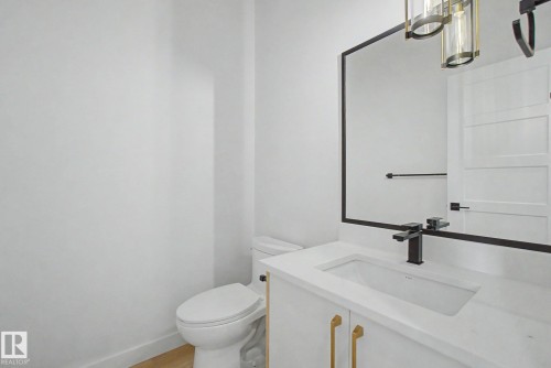 Vanity featuring an integrated rectangular sink, white countertop, and matte black faucet - 2 Willow Heights Drive, Stony Plain, AB 