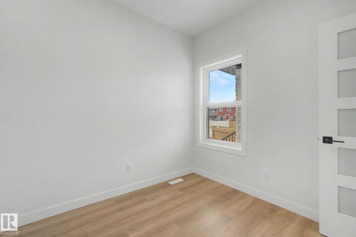 Neutral wall paint with wood-finish flooring - 2 Willow Heights Drive, Stony Plain, AB 