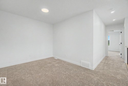 Neutral-toned carpeting and white walls define this interior space, featuring a recessed ceiling light - 2 Willow Heights Drive, Stony Plain, AB 