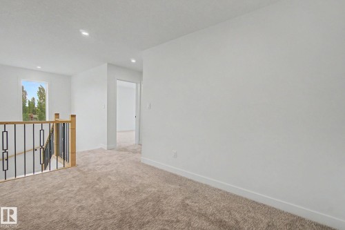 Upper-level landing featuring neutral-toned carpeting, white walls, and recessed lighting - 2 Willow Heights Drive, Stony Plain, AB 