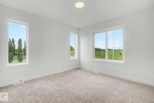 Bright interior space featuring three large windows with white trim - 2 Willow Heights Drive, Stony Plain, AB 