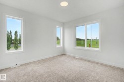 Bright interior space featuring three large windows with white trim - 