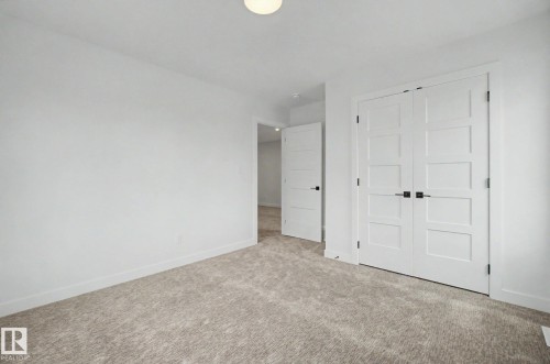 Neutral-toned carpeting complements the white walls and trim - 2 Willow Heights Drive, Stony Plain, AB 