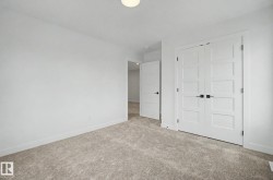 Neutral-toned carpeting complements the white walls and trim - 