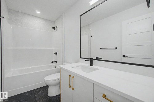 Bathroom featuring a single vanity with a white countertop, undermount sink, and matte black faucet - 2 Willow Heights Drive, Stony Plain, AB 