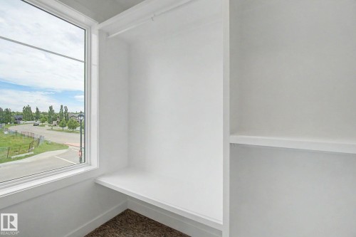 Built-in closet system featuring white shelving and a hanging rod - 2 Willow Heights Drive, Stony Plain, AB 