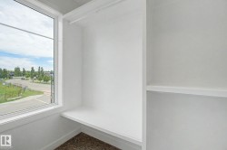 Built-in closet system featuring white shelving and a hanging rod - 
