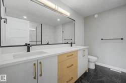 Spacious vanity with dual integrated sinks and matte black fixtures - 
