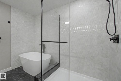 Freestanding soaking tub and glass-enclosed shower with matte black fixtures - 2 Willow Heights Drive, Stony Plain, AB 