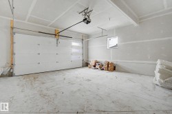 Spacious garage with a white sectional door featuring horizontal frosted glass panels - 