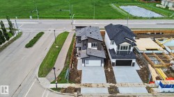 Modern residential property with dark shingle roof and a two-car garage - 