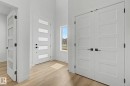 Entryway featuring a contemporary white door with frosted glass panels and matte black hardware - 2 Willow Heights Drive, Stony Plain, AB 