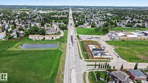 Expansive aerial perspective showcasing a developed suburban area with residential properties and green spaces - 2 Willow Heights Drive, Stony Plain, AB 