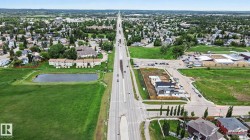 Expansive aerial perspective showcasing a developed suburban area with residential properties and green spaces - 