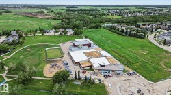 Expansive property featuring a large institutional building with multiple rooflines - 