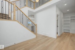 Light wood-finish flooring complements the white walls - 
