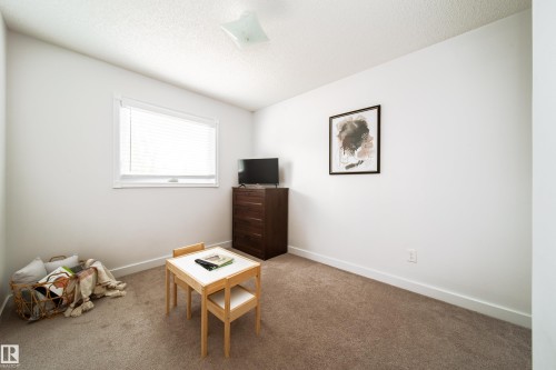 Neutral-toned wall-to-wall carpeting complements bright white walls and trim - 5607 188A Street, Edmonton, AB 
