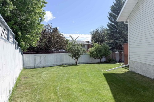 Expansive lawn with mature trees and perimeter fencing - 5607 188A Street, Edmonton, AB 