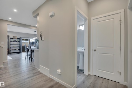 Entryway featuring light wood-finish flooring and a neutral color palette - 157 Larch Crescent, Leduc, AB 