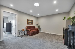 Carpeted room featuring recessed lighting, a circular ceiling light fixture, neutral wall finishes, and a white interior door frame - 
