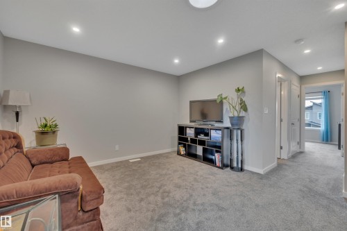 Carpeted room with light grey wall paint and recessed ceiling lights - 157 Larch Crescent, Leduc, AB 