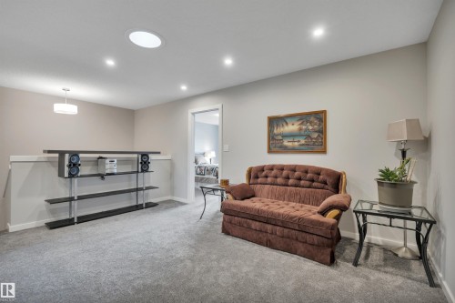 Carpeted landing with recessed lighting, a circular skylight, and neutral wall paint - 157 Larch Crescent, Leduc, AB 