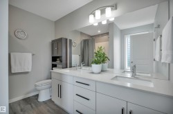 Dual vanity with white cabinetry and integrated sinks set in a light-toned countertop - 