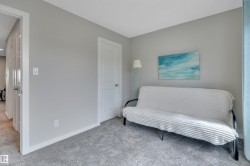 Carpeted room featuring light gray walls, white trim, and white interior doors - 