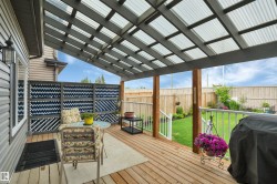 Covered outdoor deck featuring wood-finish flooring - 