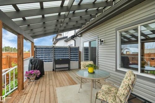 Covered outdoor patio area featuring a wooden deck - 157 Larch Crescent, Leduc, AB 