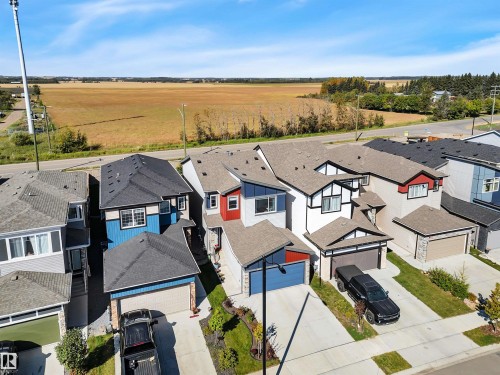 Contemporary residential architecture featuring varied exterior finishes including siding and stone accents - 157 Larch Crescent, Leduc, AB 