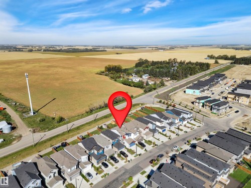 Aerial overview showcasing a residential development with varied housing styles - 157 Larch Crescent, Leduc, AB 