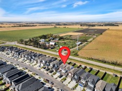 Aerial perspective showcasing a residential street with uniform homes, each featuring a private driveway and attached garage - 