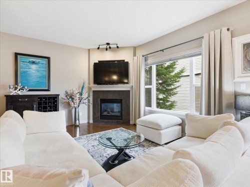 112 89 Rue Monette, Beaumont, AB - Indoor Photo Showing Living Room With Fireplace