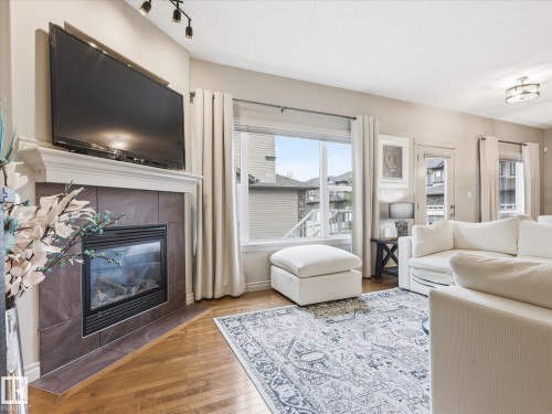 112 89 Rue Monette, Beaumont, AB - Indoor Photo Showing Living Room With Fireplace