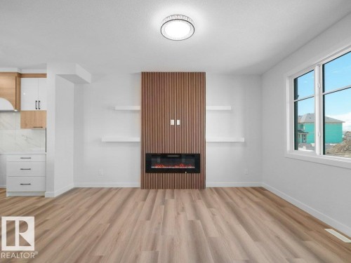 Open-concept living area with contemporary wood-finish flooring - 18723 130 Street, Edmonton, AB 