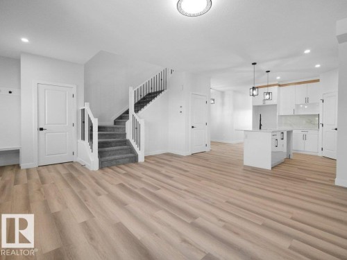 Open-concept interior featuring light wood-finish flooring - 18723 130 Street, Edmonton, AB 