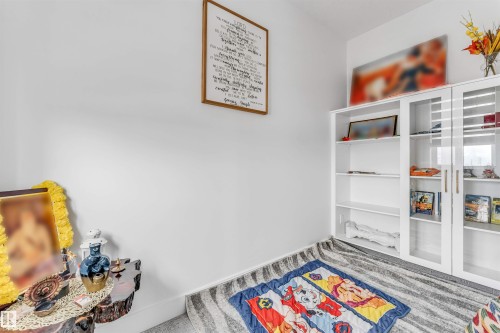 White painted walls with a framed wall hanging - 208 33 Street, Edmonton, AB 