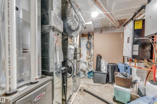 Utility area featuring a forced-air furnace, extensive ductwork, and various mechanical systems - 208 33 Street, Edmonton, AB 