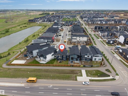 Modern residential development featuring a structured street grid, a large pond, extensive green spaces, and a variety of contemporary home designs - 208 33 Street, Edmonton, AB 