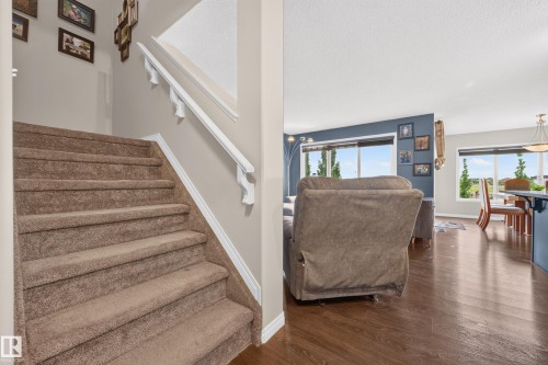 Carpeted staircase with white handrails and trim - 74 Santana Crescent, Fort Saskatchewan, AB 