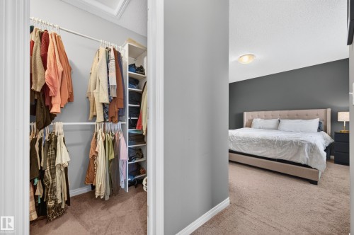 Walk-in closet featuring built-in shelving and hanging rods - 74 Santana Crescent, Fort Saskatchewan, AB 