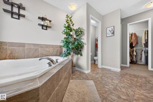 Oversized soaking tub with tiled surround and chrome fixtures - 74 Santana Crescent, Fort Saskatchewan, AB 