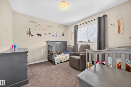 Carpeted room featuring a window with blinds, a ceiling-mounted light fixture, and neutral-toned walls - 74 Santana Crescent, Fort Saskatchewan, AB 
