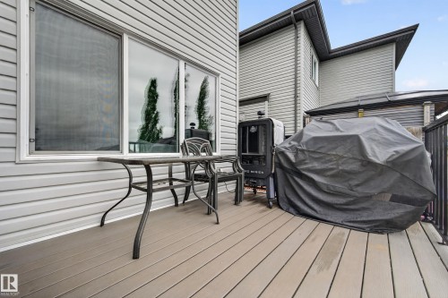 Composite deck with grey siding and white framed windows - 74 Santana Crescent, Fort Saskatchewan, AB 