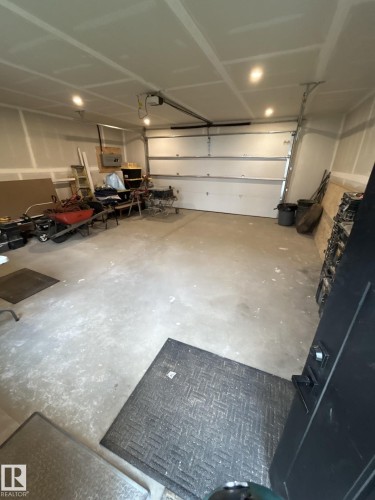 Interior 23'x22' with an 8' garage door height. Newly built and is insulated, drywalled and taped with a heater, garage door opener and new 200 amp panel - 7924 92 Avenue, Edmonton, AB 