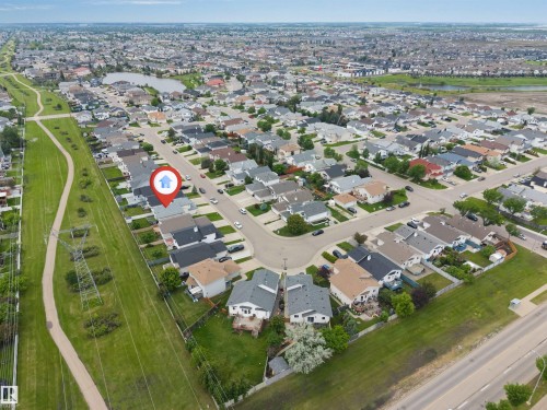 Aerial perspective of a suburban neighborhood featuring residential homes with varied rooflines and landscaping - 6719 164 Ave, Edmonton, AB 